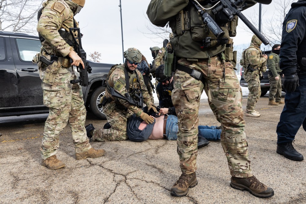Federal agents arrest protestors outside an ICE facility in Minneapolis on Jan. 9.