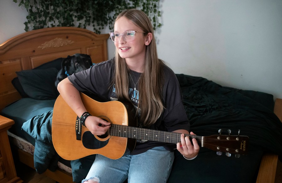 Fifteen year-old Becky Pepper-Jackson playing her guitar.