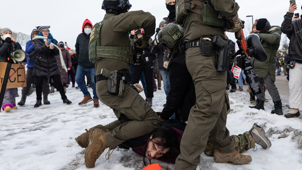 Several federal agents attempt to make an arrest at a protest against the ICE presence in Minneapolis.