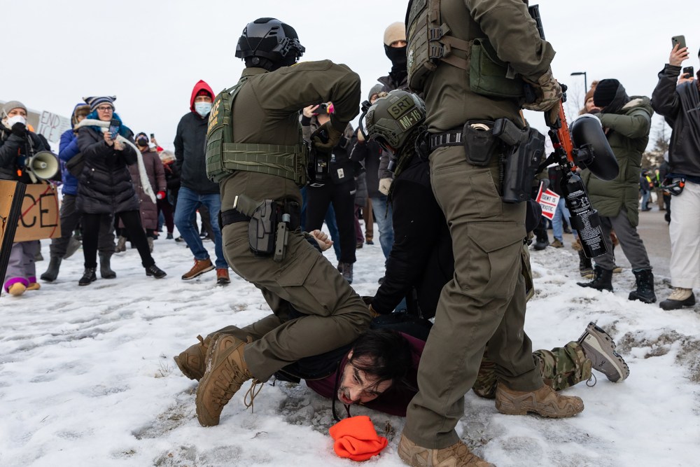 Several federal agents attempt to make an arrest at a protest against the ICE presence in Minneapolis.