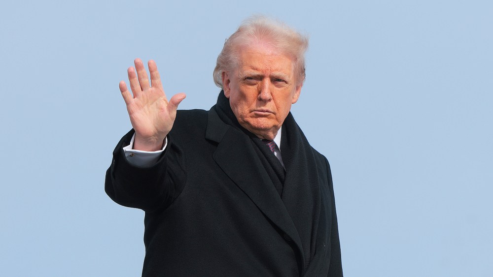 President Donald Trump waves as he boards Air Force One.