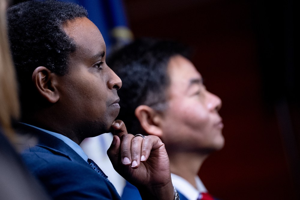 Joe Neguse looks at the podium during a press conference on Capitol Hill.
