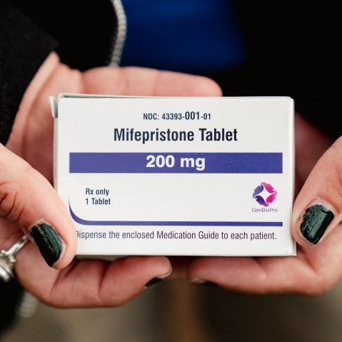 Trans man and abortion rights advocate Artemis Duffy holds a box of mifepristone on March 26, 2024 outside the U.S. Supreme Court.