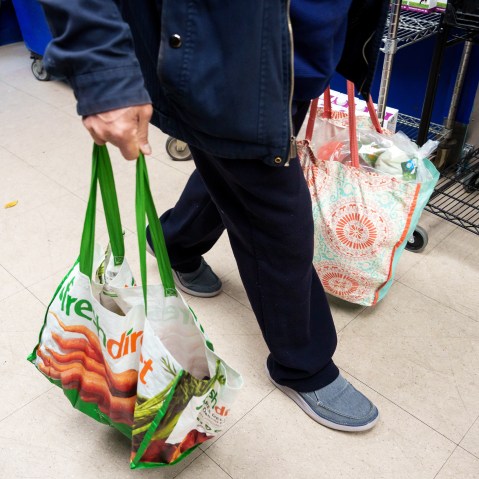 A resident carries grocery bags on Oct. 31, 2025, in New York.