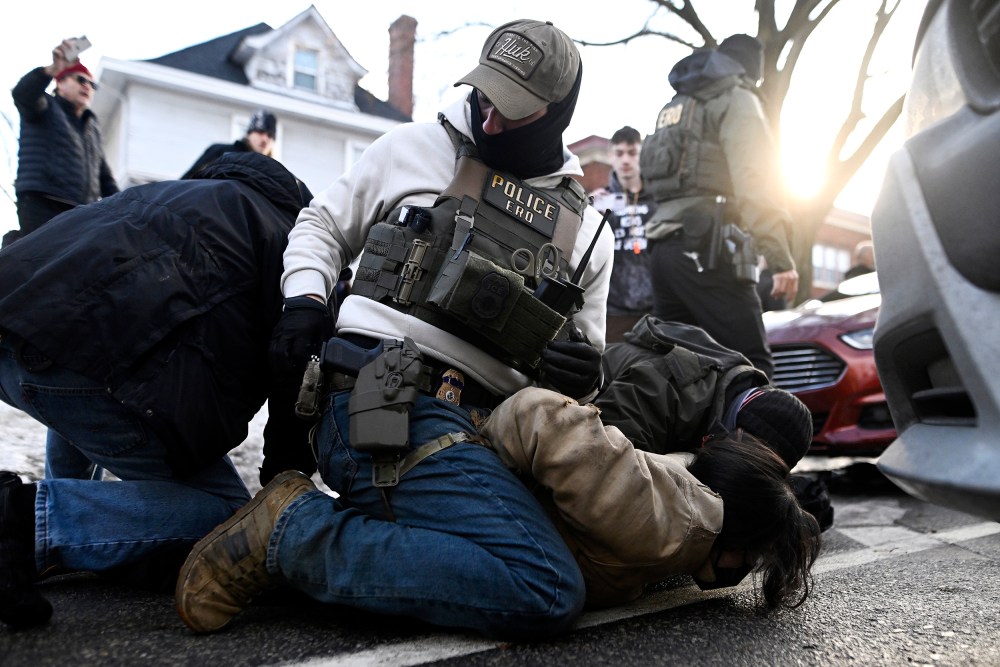 An observer is detained by ICE agents on Jan. 13, 2026 in Minneapolis, MN.