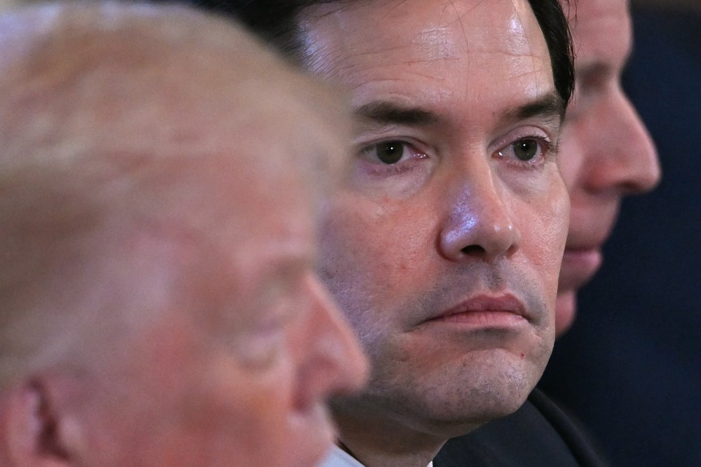 A closeup of Marco Rubio&rsquo;s face during a meeting in the White House. To his left, Donald Trump can be seen out of focus.