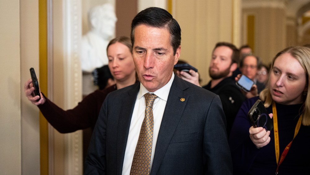 Bernie Moreno followed by reporters.