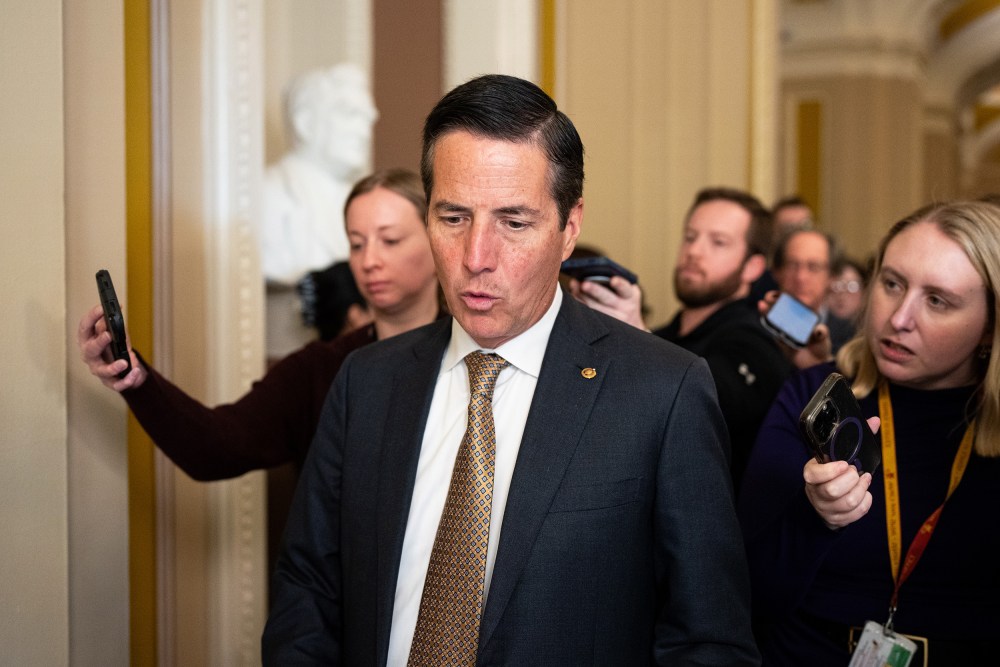 Bernie Moreno followed by reporters.