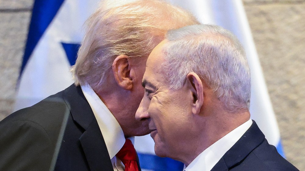 President Donald Trump's face is obscured behind Benjamin Netanyahu's.