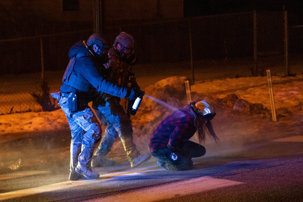 Federal agents deploy tear gas and pepper balls against community members during protest in north Minneapolis, MN.
