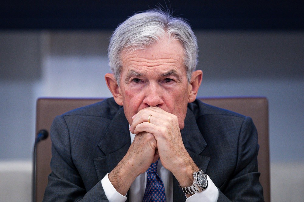 Jerome Powell sits with his hands clasped in front of his mouth.