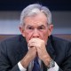 Jerome Powell sits with his hands clasped in front of his mouth.