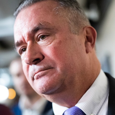 Republican Rep. Bacon stands in front of reporters, seen in a very tight shot of his face.