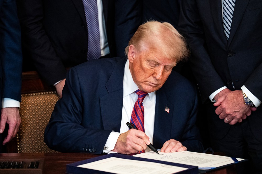 President Donald Trump signing an act on July 18, 2025, during a ceremony in the East Room of the White House.