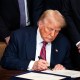 President Donald Trump signing an act on July 18, 2025, during a ceremony in the East Room of the White House.