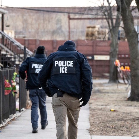 U.S. Immigration and Customs Enforcement agents walk down a street on Jan. 26, 2025, in Chicago.