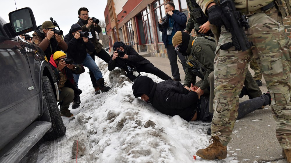 US Customs and Border Protection agents arrest a man while patrolling a neighborhood on Jan. 11, 2026 in Minneapolis.