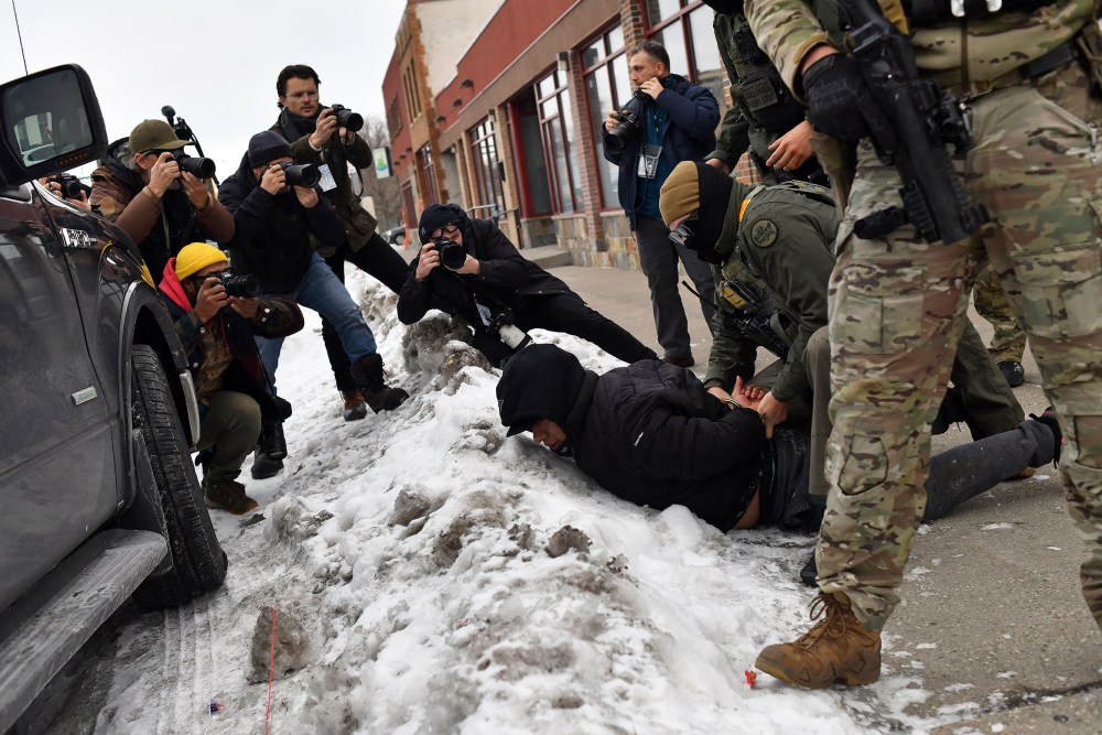 US Customs and Border Protection agents arrest a man while patrolling a neighborhood on Jan. 11, 2026 in Minneapolis.