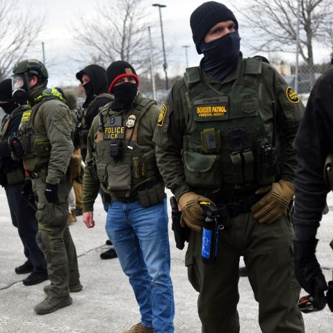 Federal law enforcement agents confront anti-ICE protesters during a demonstration on Jan. 15, 2026 in Minneapolis, MN.