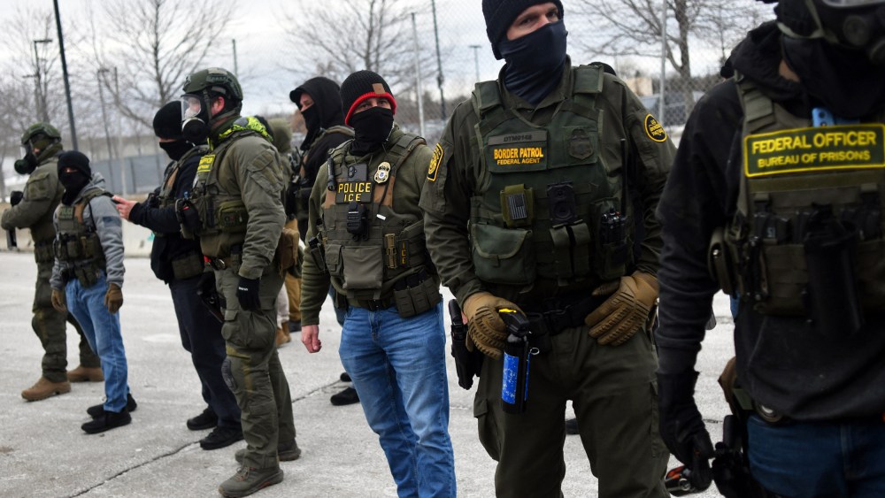 Federal law enforcement agents confront anti-ICE protesters during a demonstration on Jan. 15, 2026 in Minneapolis.