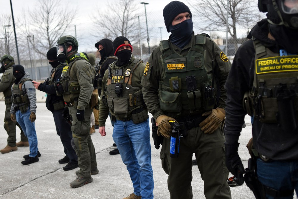Federal law enforcement agents confront anti-ICE protesters during a demonstration on Jan. 15, 2026 in Minneapolis, MN.