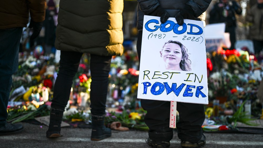 A person holds a sign reading "Good Rest in Power" during a vigil on Jan. 14, 2026, in Minneapolis.