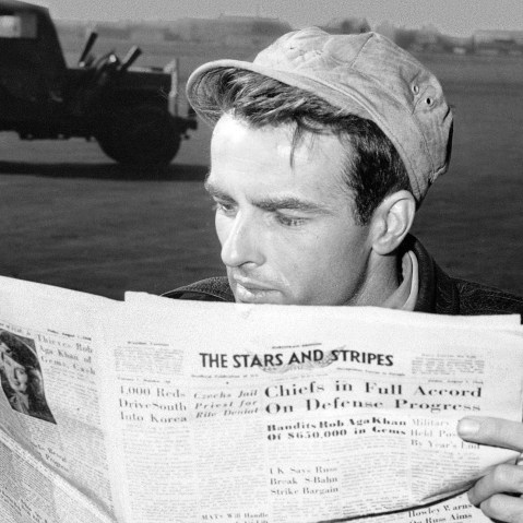 American actor Montgomery Clift reading a copy of 'The Stars and Stripes' in Berlin circa 1950.