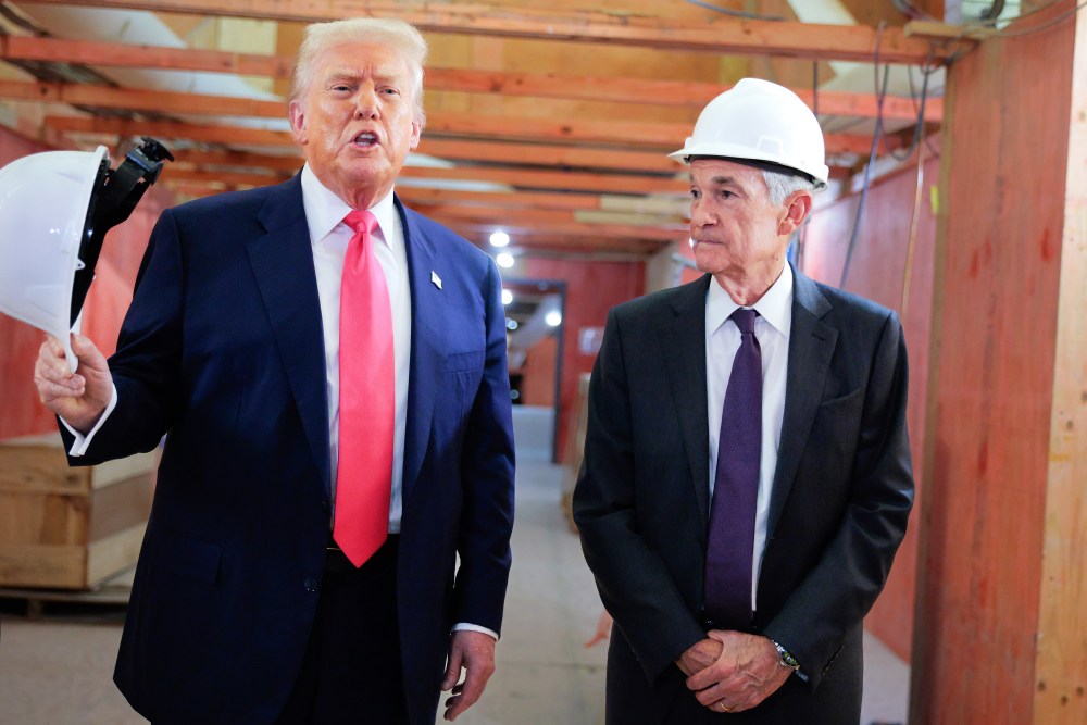 President Trump stands to the left of Fed Chair Jerome Powell as he speaks to the media.